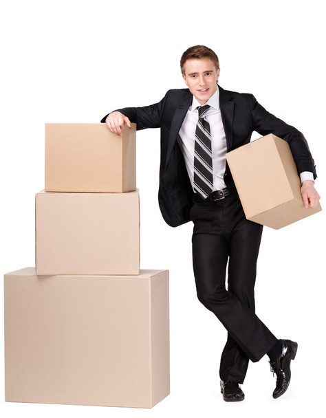 Manager stands near pile of cardboard boxes - Fotografie, Obrázek