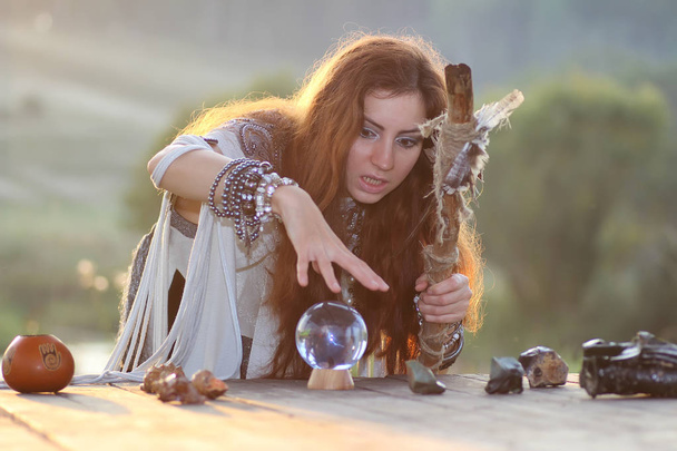 witch with crystal ball at sunset - Fotoğraf, Görsel