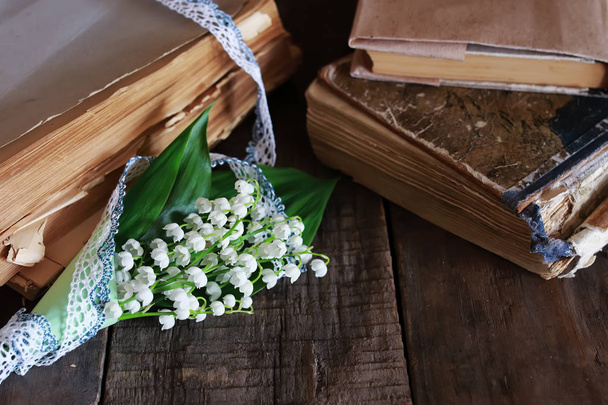 bouquet of fresh lilies of the valley and retro book - Photo, Image