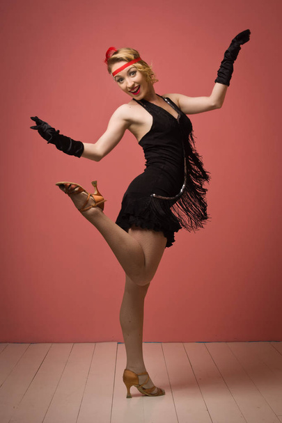 Pretty actress in black retro dress dancing charleston - Фото, изображение