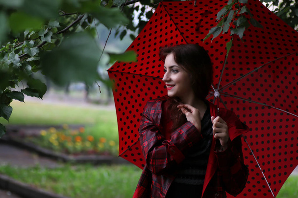 woman in a raincoat and an umbrella - Φωτογραφία, εικόνα