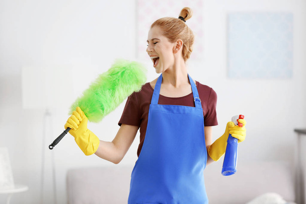 woman with duster and detergent - Фото, изображение