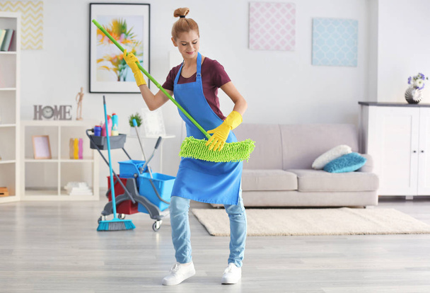 woman with mop in living room - Fotografie, Obrázek
