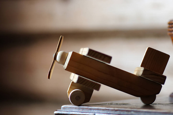 wooden toy airplane on the table - 写真・画像