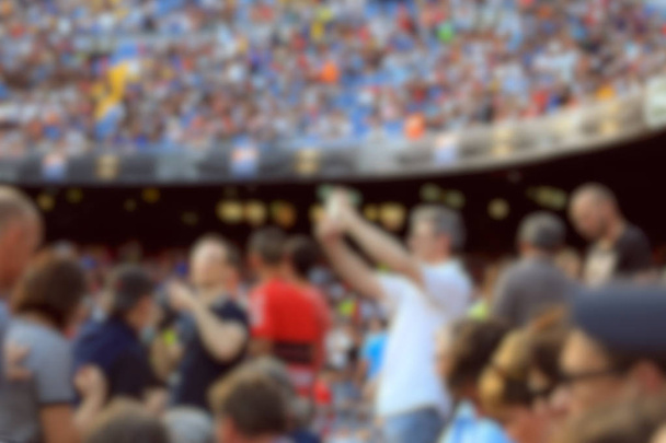 Blurred crowd of spectators on stadium at a sporting event - Photo, Image