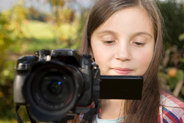 Teenage girl with a camera - Photo, Image