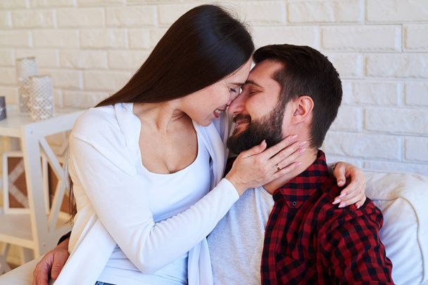 Charming couple tenderly embracing and touching foreheads while  - Photo, Image