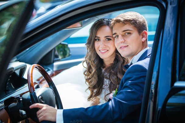 Happy newlyweds inside a car - Φωτογραφία, εικόνα