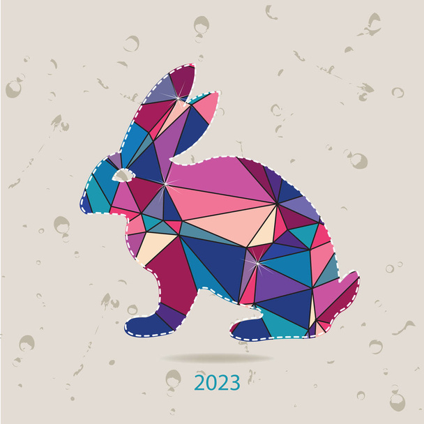 La tarjeta de año nuevo de 2023 con conejo hechas de triángulos - Vector, imagen