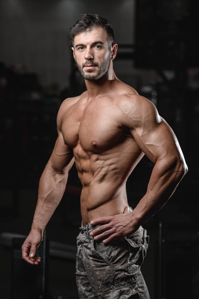 Strong and handsome athletic young man muscles abs and bicep fitness and bodybuilding - 写真・画像