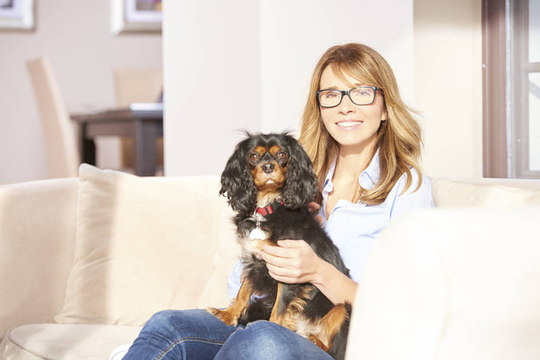  woman enjoying time with her pet - 写真・画像