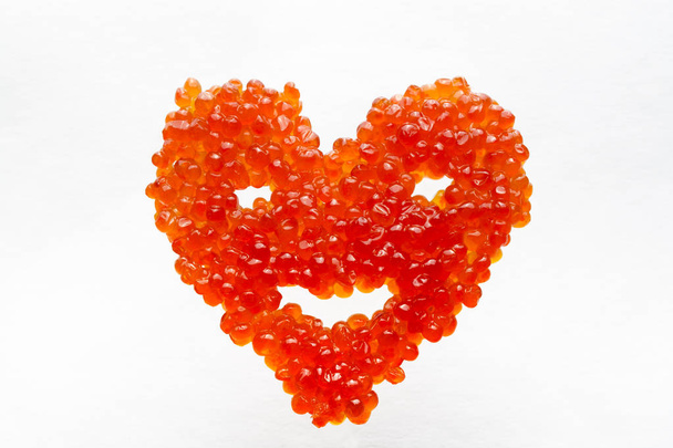Smiling heart made of red caviar - Photo, Image