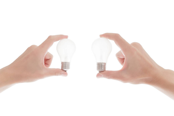 Lightbulb in a hand isolated on white background - Foto, Imagen