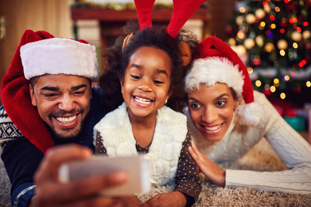 mother, father and daughter - Christmas selfie - Photo, image