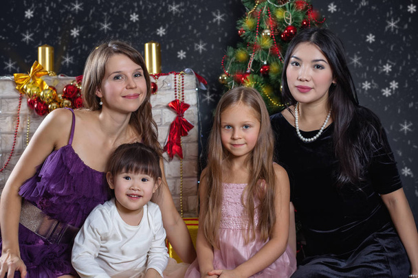 Lesbian interracial family in the background of Christmas - Foto, Bild