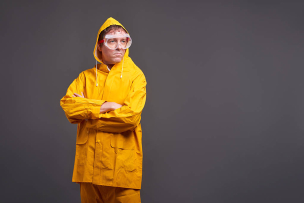 Man in yellow raincoat	 - Фото, изображение