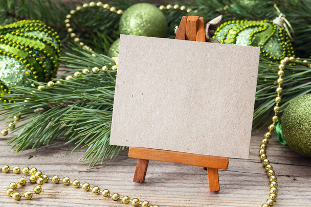 Miniature easel with blank card, pine branches and Christmas dec - Photo, Image