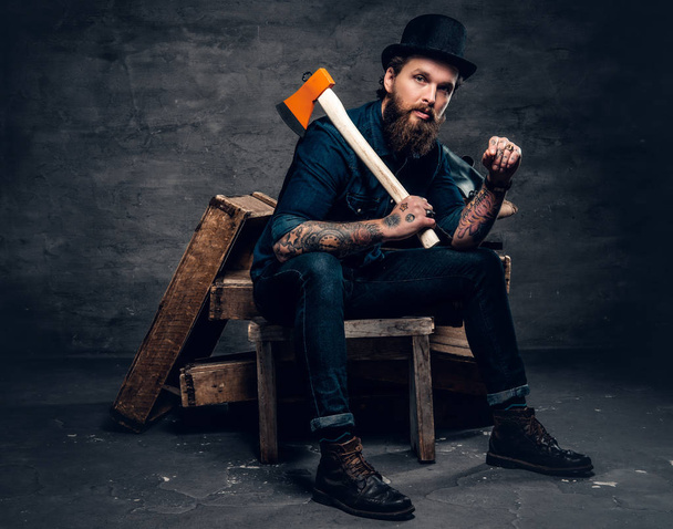 Hipster with tattooed arms holding axe - Photo, Image