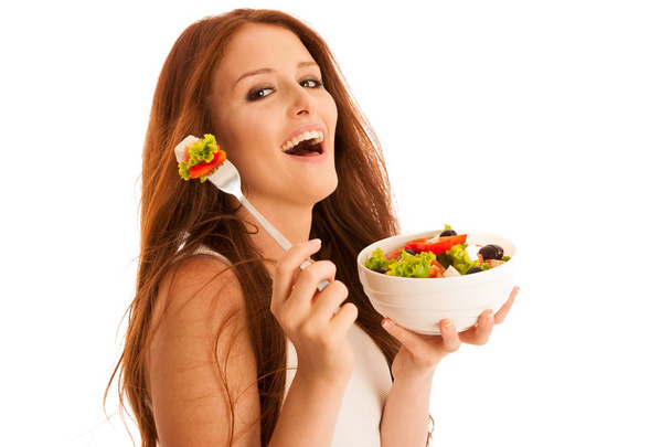 здоровое питание - женщина ест миску греческого салата изолированы над
 - Фото, изображение