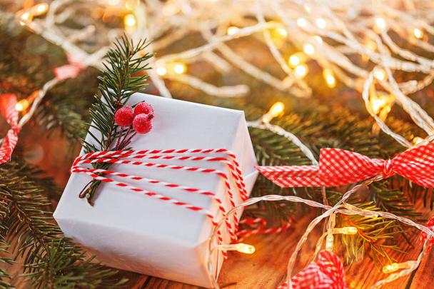 Christmas Decoration gift box and gold jingle bells with branch fir  boke. Holiday greeting card. - Φωτογραφία, εικόνα