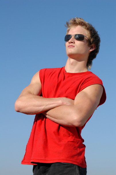 Muscular Young Man in Red - 写真・画像
