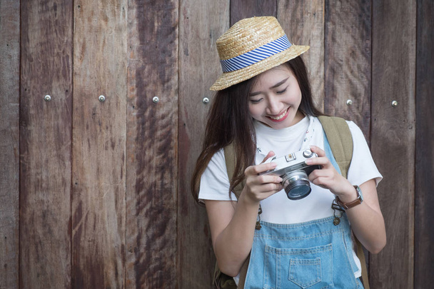 Young asian butiful woman with camera. in a blue shirt. Hipster  - Photo, Image