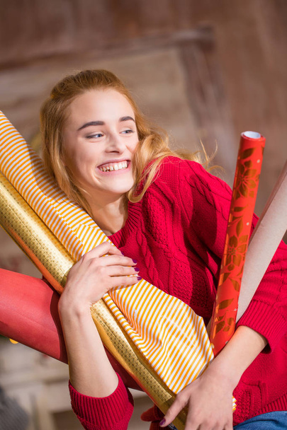 Woman holding rolls of wrapping paper - Photo, image