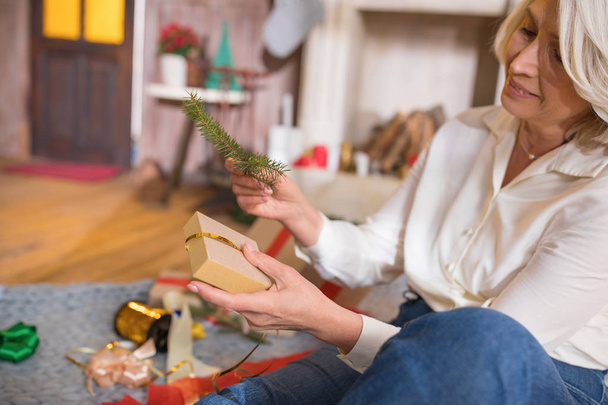 Woman wrapping christmas present - 写真・画像