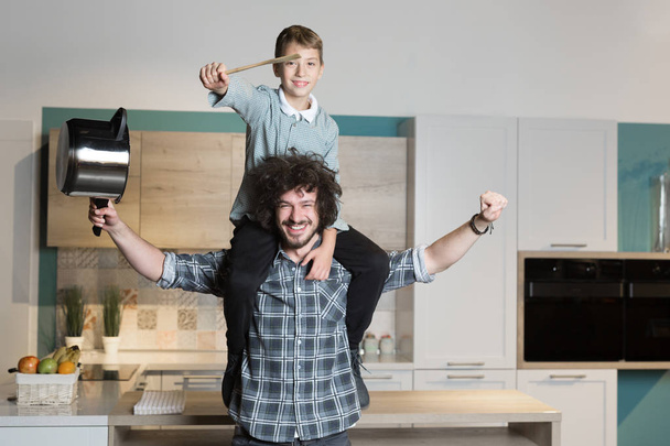 father and kid having great time in kitchen - Photo, Image