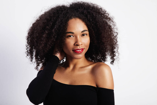 pretty black woman touches her curly hair - Photo, Image