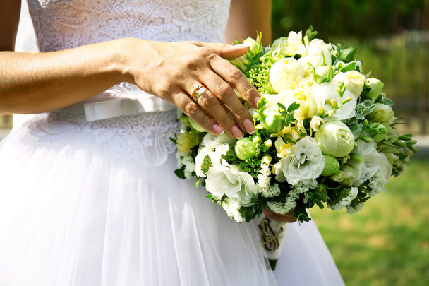Bride holding wedding bouquet  - Fotó, kép