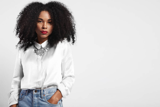 black woman wears jeans and white silk shirt.  - Photo, Image