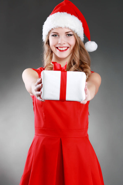 Christmas isolated woman portrait hold red christmas gift. - Fotoğraf, Görsel