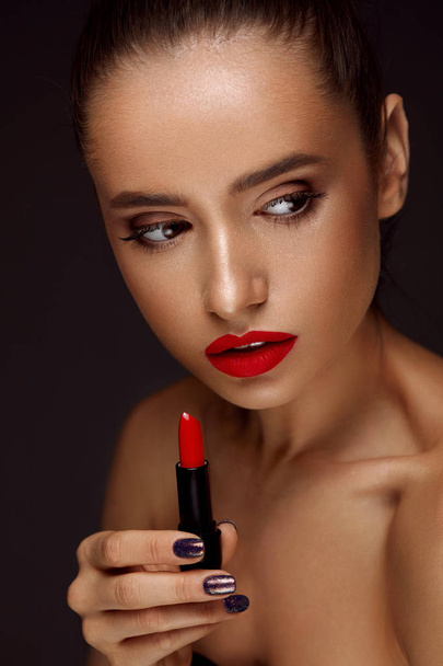 Beautiful Woman With Bright Red Lips And Lipstick In Hand - Foto, Imagen