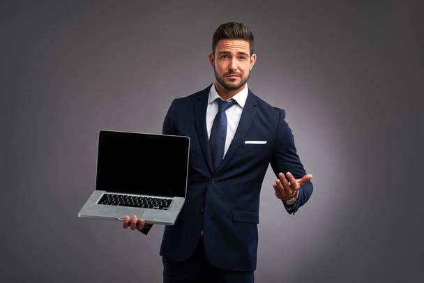 Elegant young man with laptop	 - Foto, afbeelding
