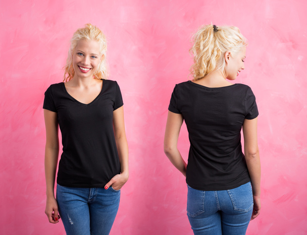 Woman in black V-neck T-shirt on pink background - Photo, Image