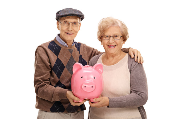 Happy seniors with a piggybank - Фото, изображение