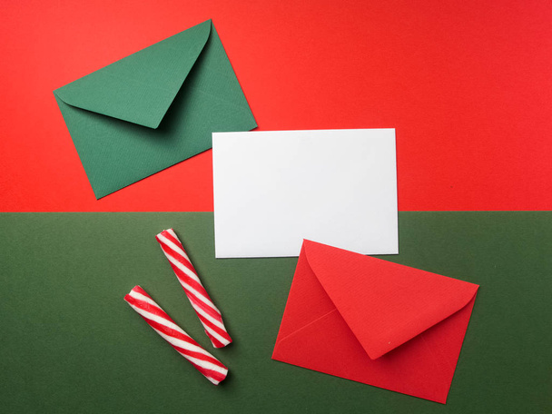 Red and green envelopes on christmas holiday background. Flat lay. - Photo, Image