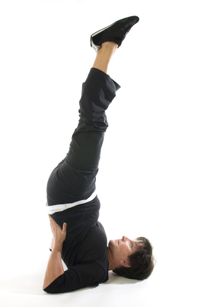 middle age woman demonstrating yoga position half shoulderstand - Fotó, kép