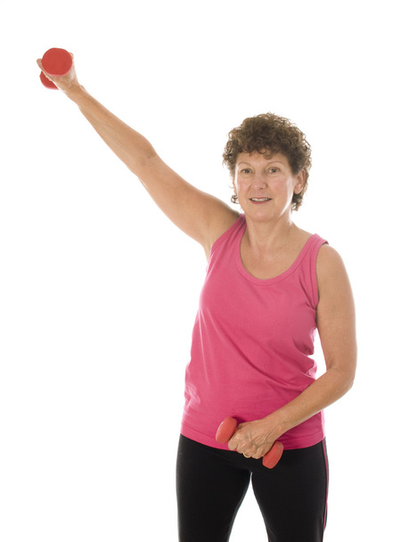senior middle age woman exercising with dumbbells - Foto, Imagen