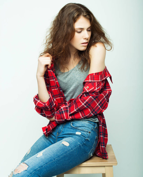 lifestyle, fashion and people concept: young curly woman posing in studio - 写真・画像