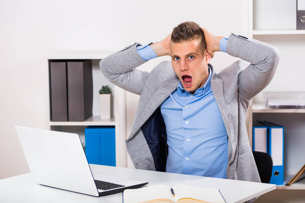 Businessman sitting at office in panic - Photo, Image