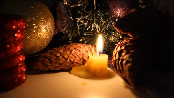 Burning candle on a background of Christmas decorations. - Кадри, відео