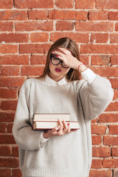 Stress girl with books forgot something important - Photo, image