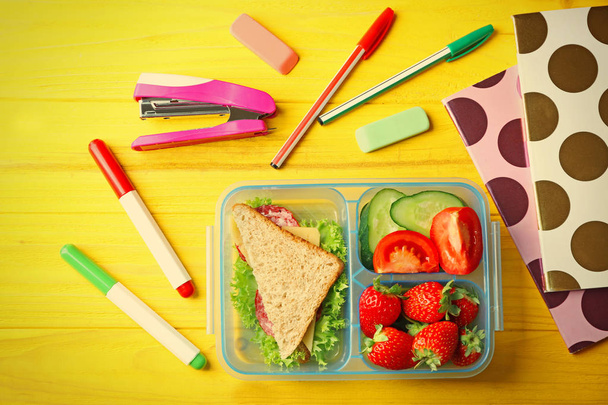 Lunch box with food and stationery - Photo, image