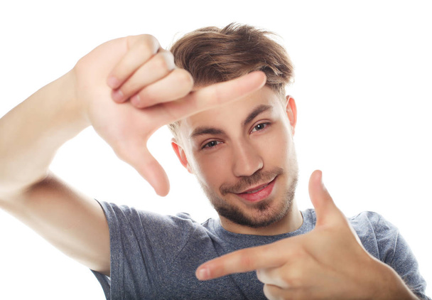 Cheerful  young man  gesturing finger frame - Fotó, kép