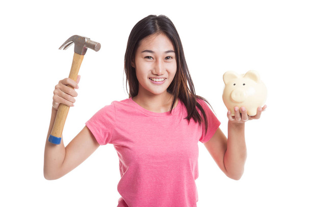 Asian woman with pig coin bank and hammer. - Valokuva, kuva