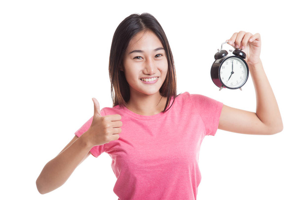 Young Asian woman show thumbs up with a clock. - Φωτογραφία, εικόνα