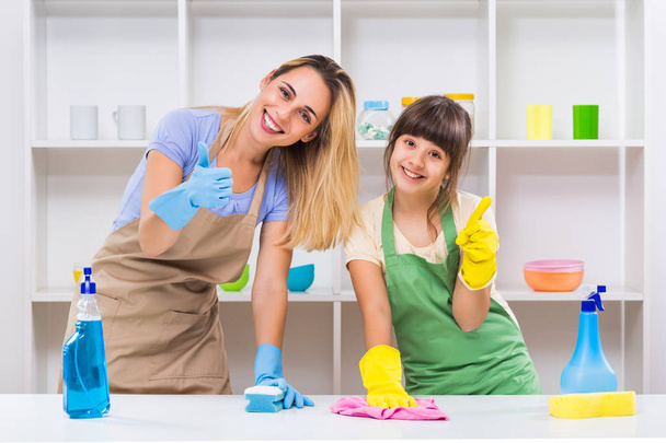Happy mother and daughter cleaning and showing thumbs up - 写真・画像