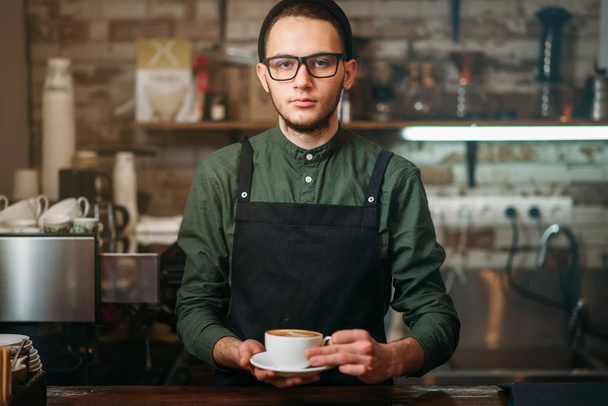 Barista holds cup of coffee - Photo, Image